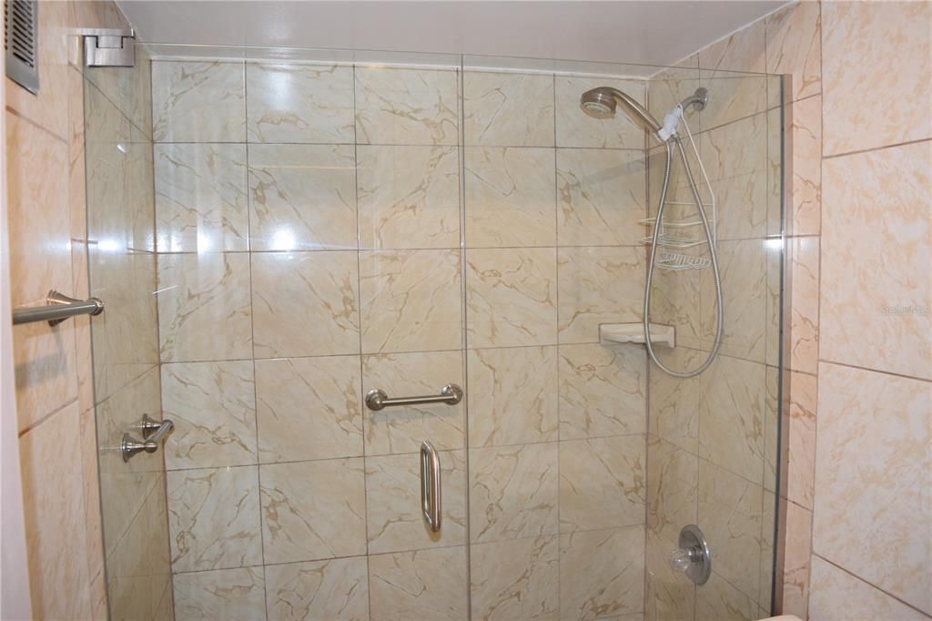 Glass enclosed shower in bathroom