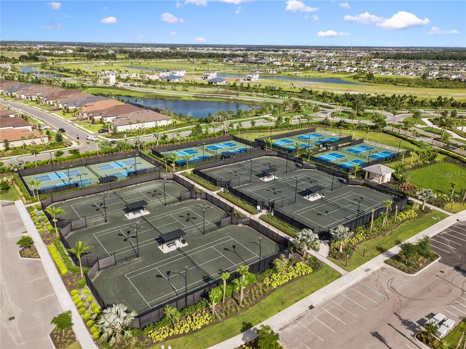 Community photo featuring pickleball and Har-Tru tennis courts.