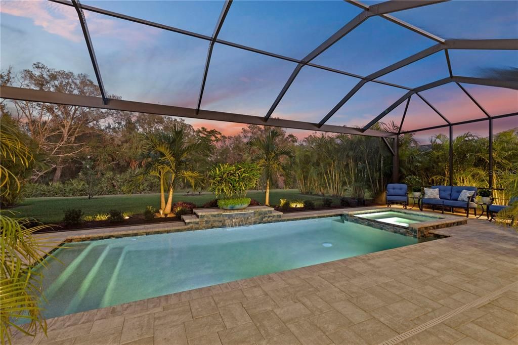 Outdoor pool featuring built in waterfall.