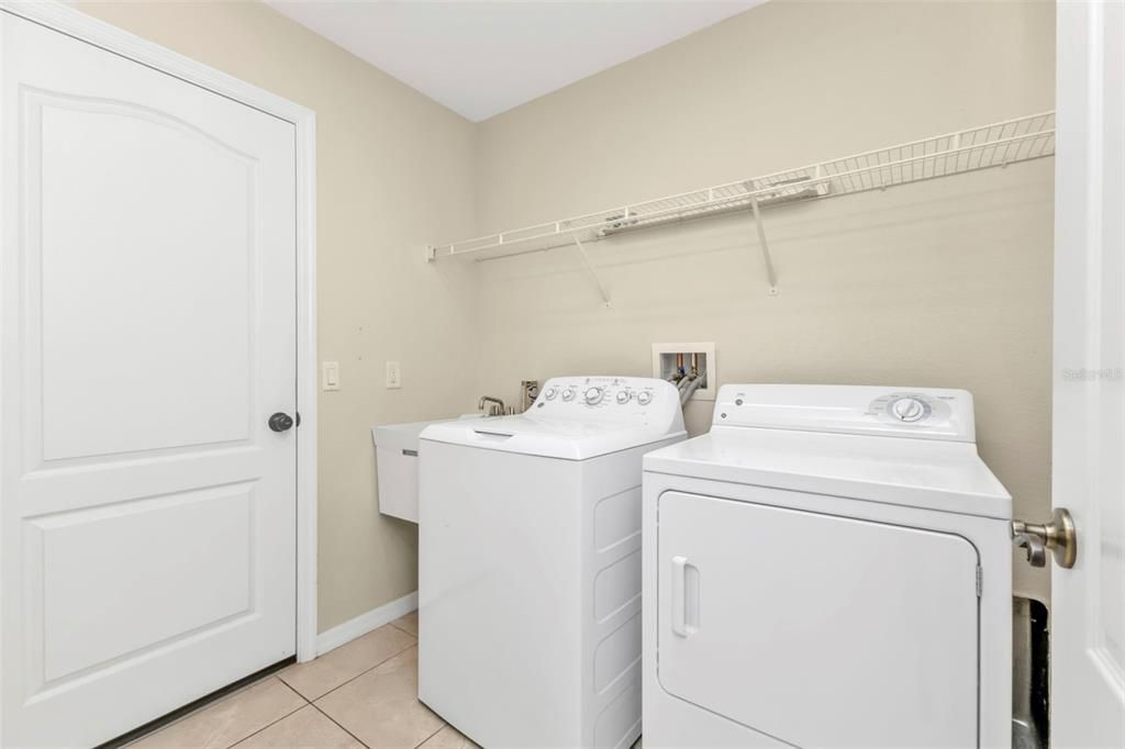 Laundry room off of kitchen. Washer & Dryer included with utility sink.