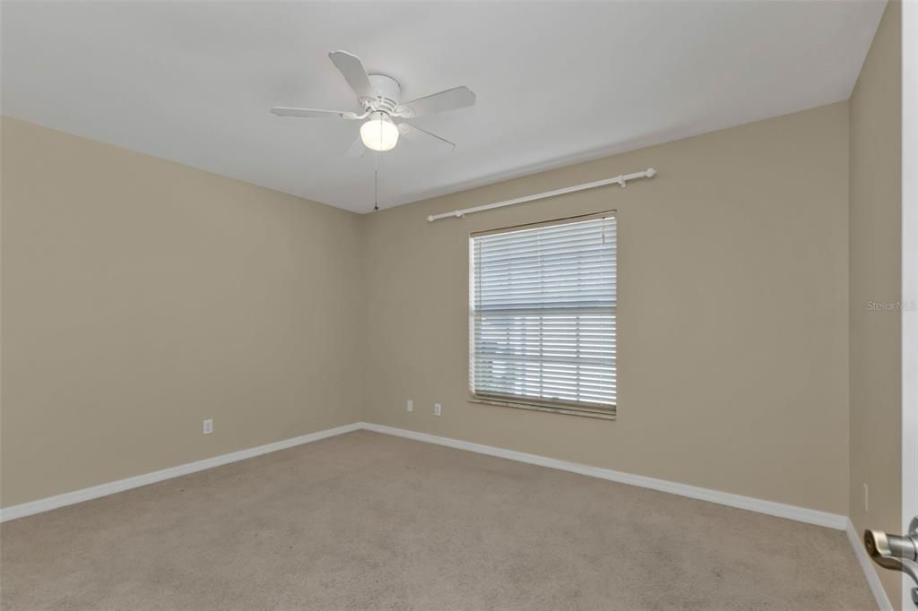 Guest bedroom 3 with carpet and built in closet.