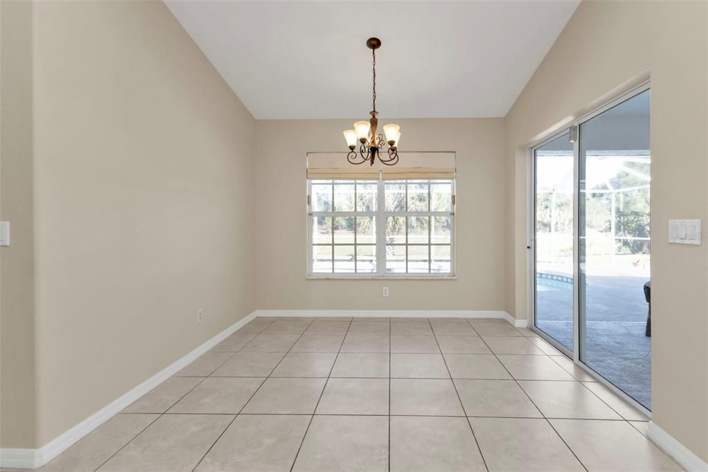 Dining room with sliding glass door to pool and lanai.