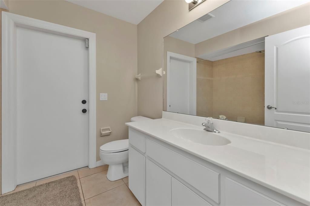 Guest bathroom with single vanity and shower/ tub combo.