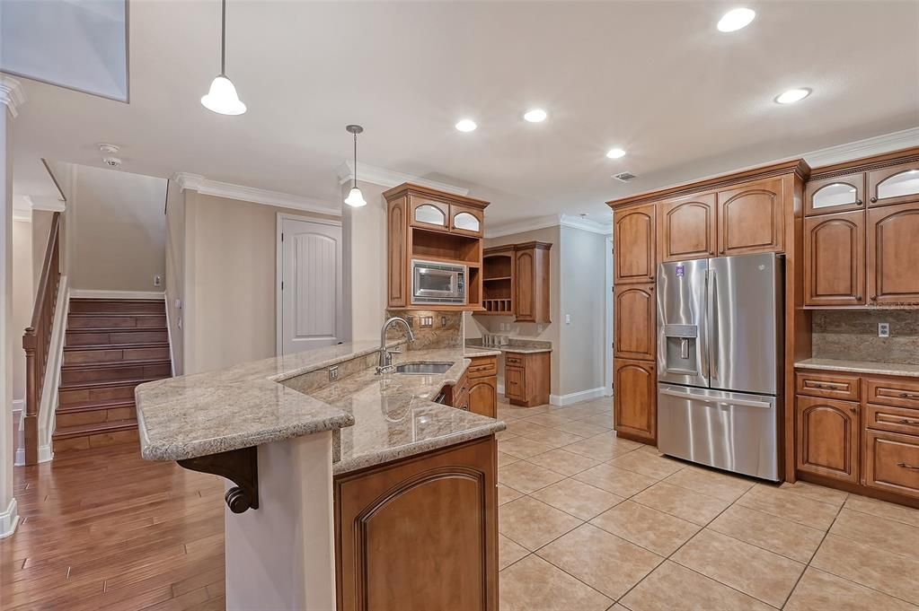 View of Kitchen with stairs entrance to second floor.