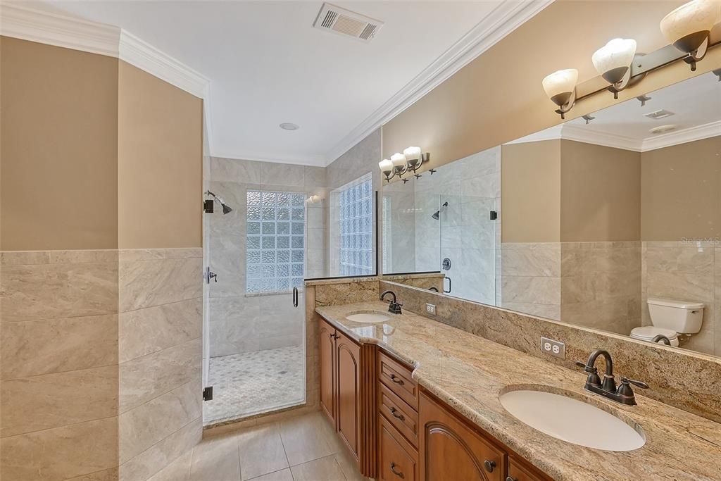 Primary Bathroom with dual vanities and walk in shower.