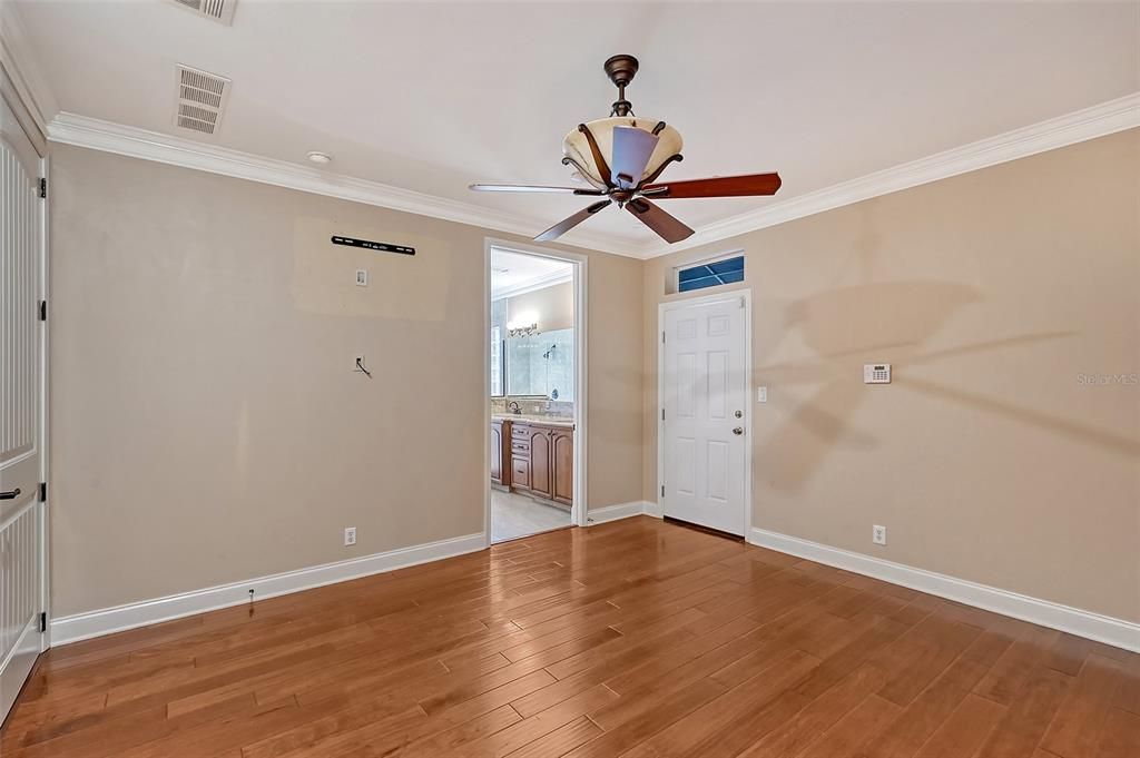 Owners Primary Bedroom with entrance view of Bathroom on first level floor.