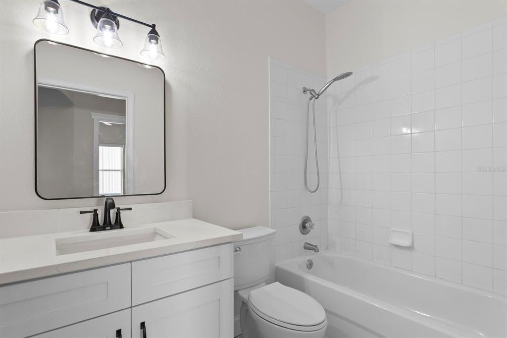 The 2nd full bath has been updated to include a new vanity, quartz counters, fixtures & lighting