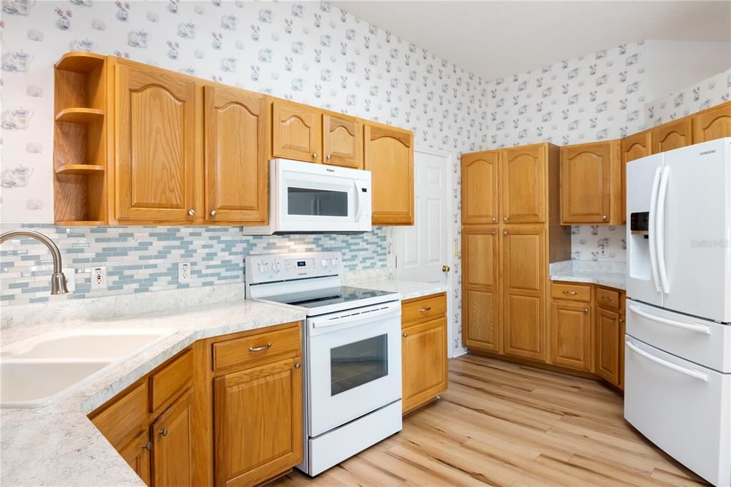 Kitchen with eat in area.  Sliding doors that go out to side patio.