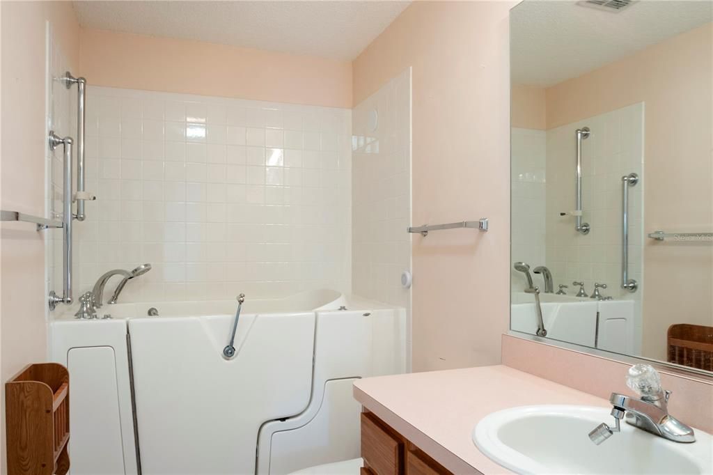 Second bathroom with walk in jacuzzi tub.