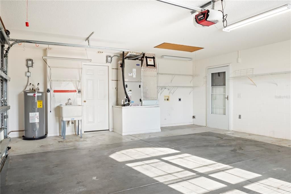 Two car garage with sink and laundry hook up.