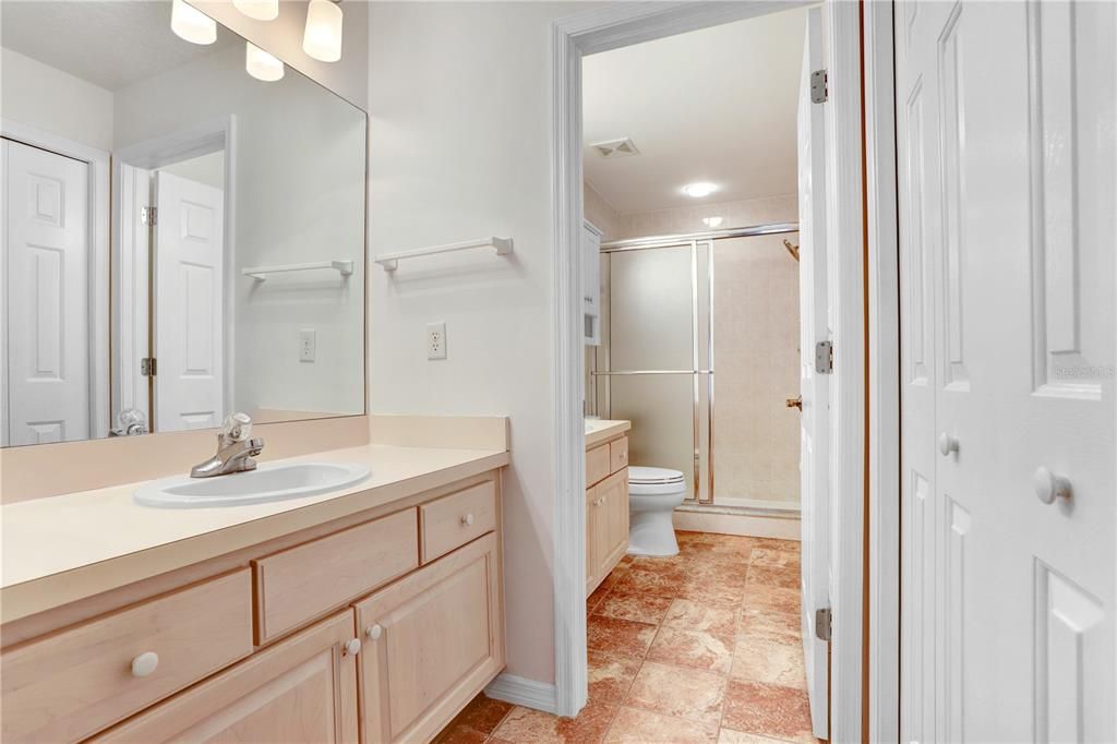 A second vanity provides extra space for storage and getting ready outside the primary bathroom