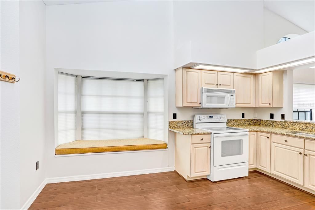 The kitchen has a beautiful window with a reading nook, allowing for even more natural light.