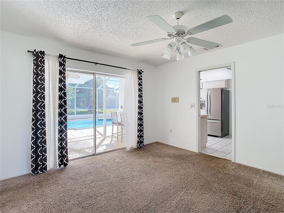 Dining Area with Pool View opens into the Kitchen