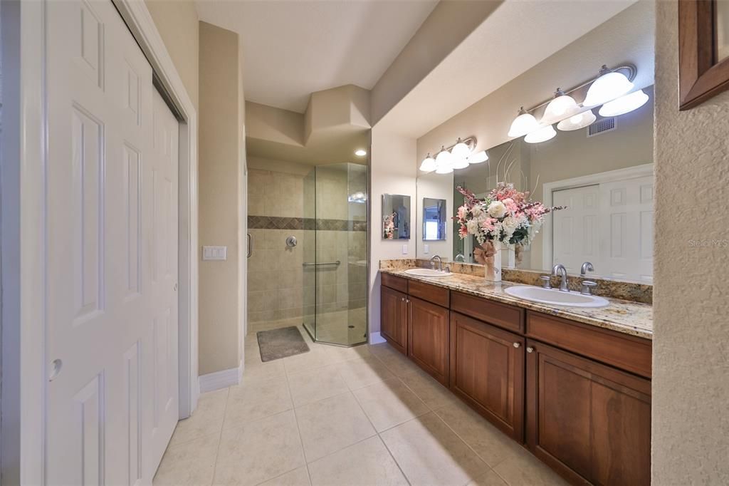 The master bath is fully updated with granite counters, glass shower and all wood cabinetry.