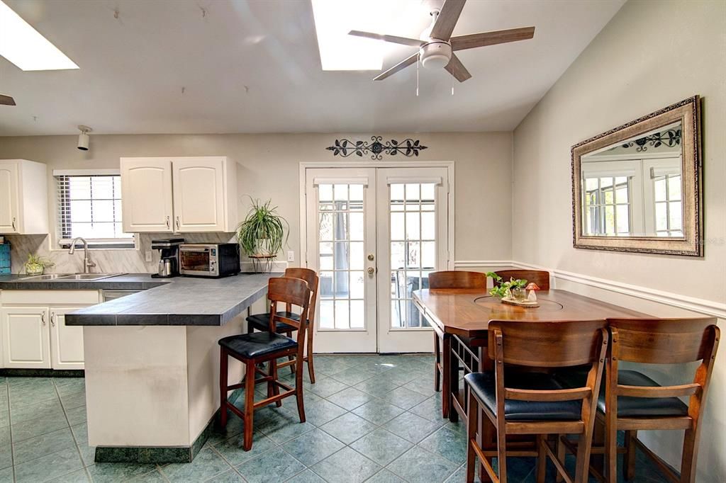 Dining Room / Breakfast Bar with French Doors to Screened Lanai