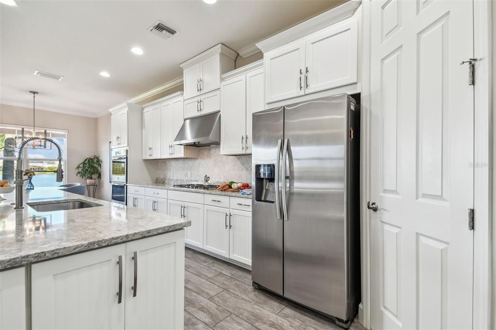 Ample cabinetry for storage as well as a reach in pantry.