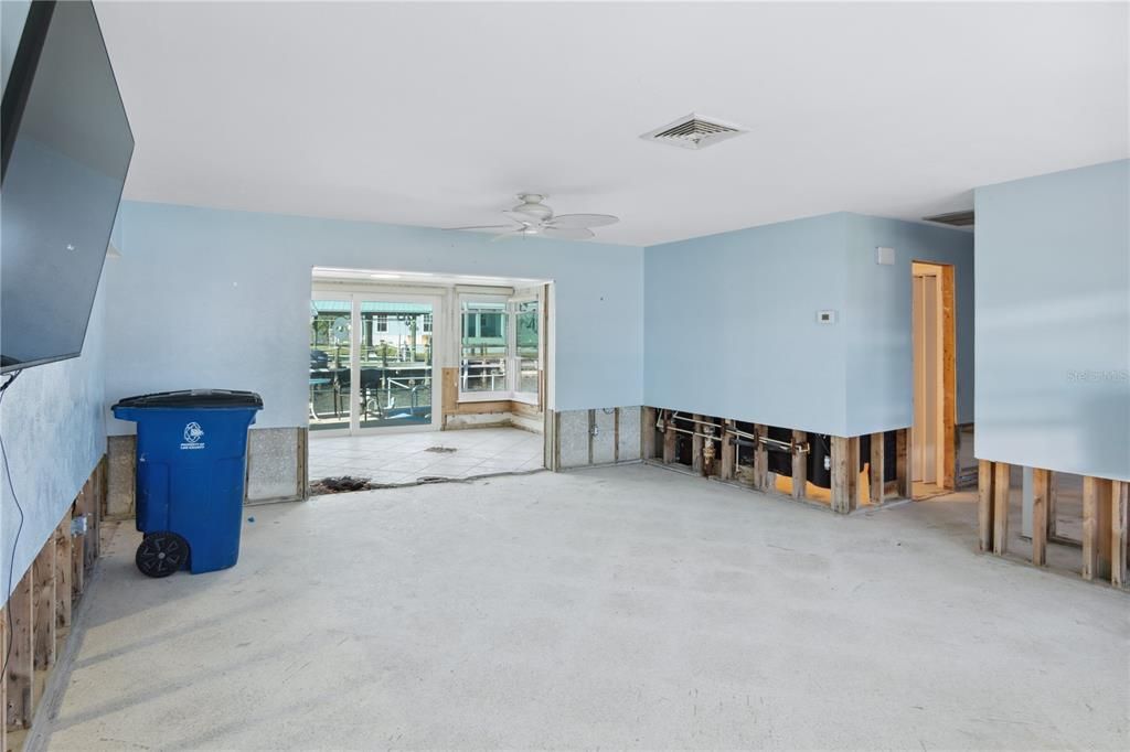 living room looking into sun room/back patio. Bedrooms down hall on the right