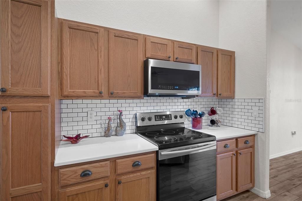 The kitchen has an abundance of beautiful cabinets