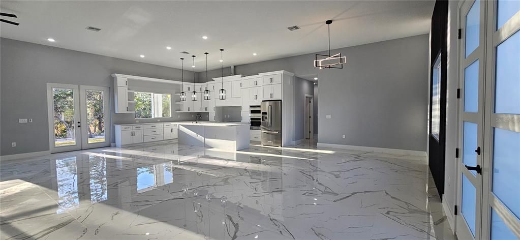 Great Room toward kitchen. Front door on right.