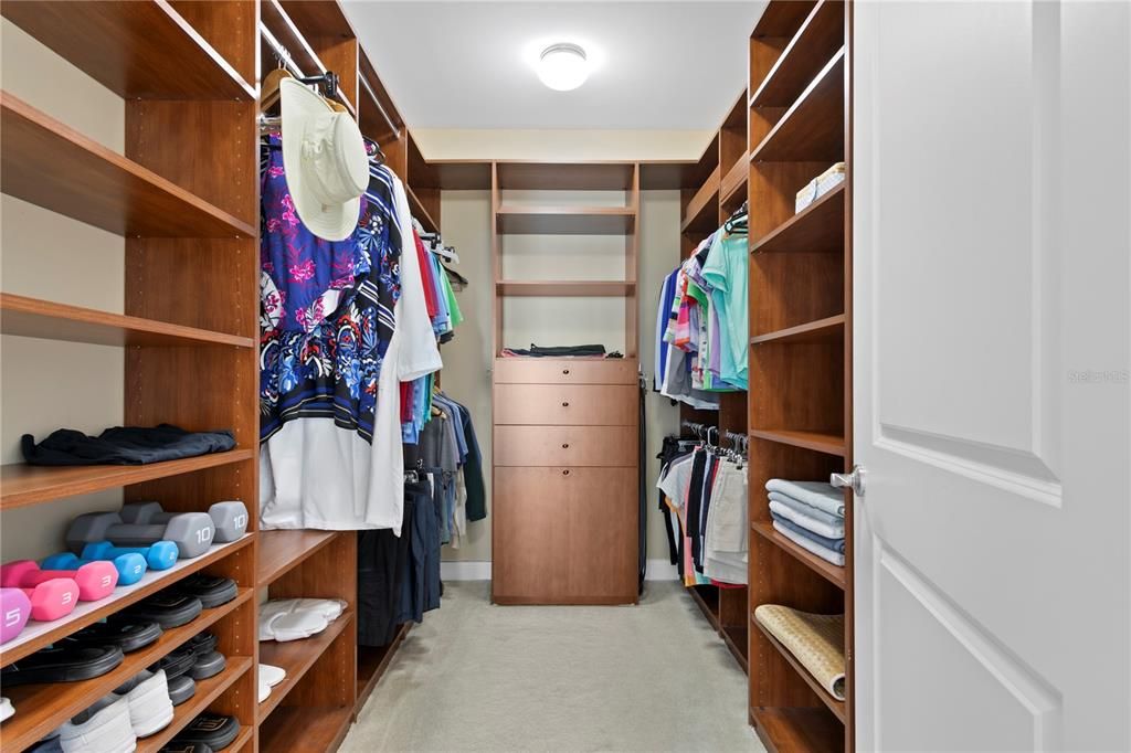 Loads of beautifully organized custom built walk in closets.