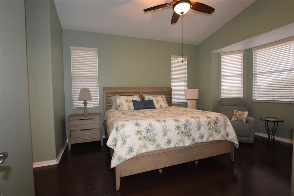 The north facing "owner's suite with "bump-out" overlooks the golf course.  The recently painted owner's suite offset the beauty of the real wood floors. (2) closets flank the hallway (on the left) which leads to the en-suite.