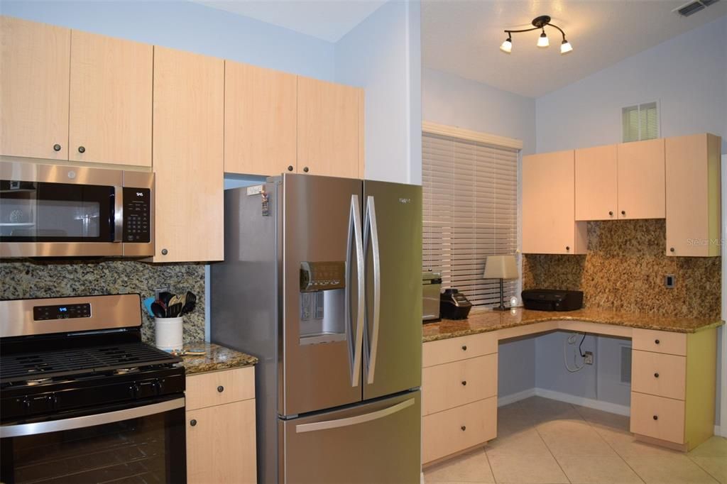 Kitchen is fully equipped with Stainless Steel w/ an oversized sink, and appliances with NEW Microwave, Gas Range, Dishwasher; French-drawer Refrigerator w/ water & ice dispenser; expanded kitchen & desk area and granite counter-tops & backsplashes.