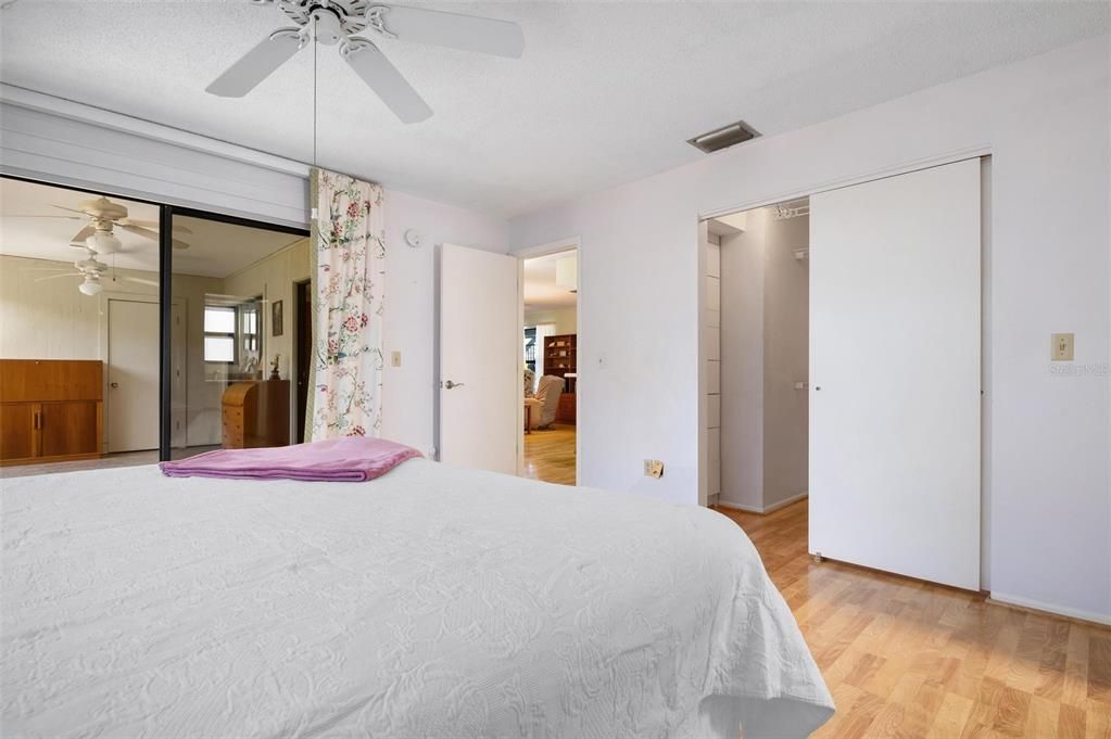 Primary bedroom with ensuite bath, walk in closet and sliding doors to lanai