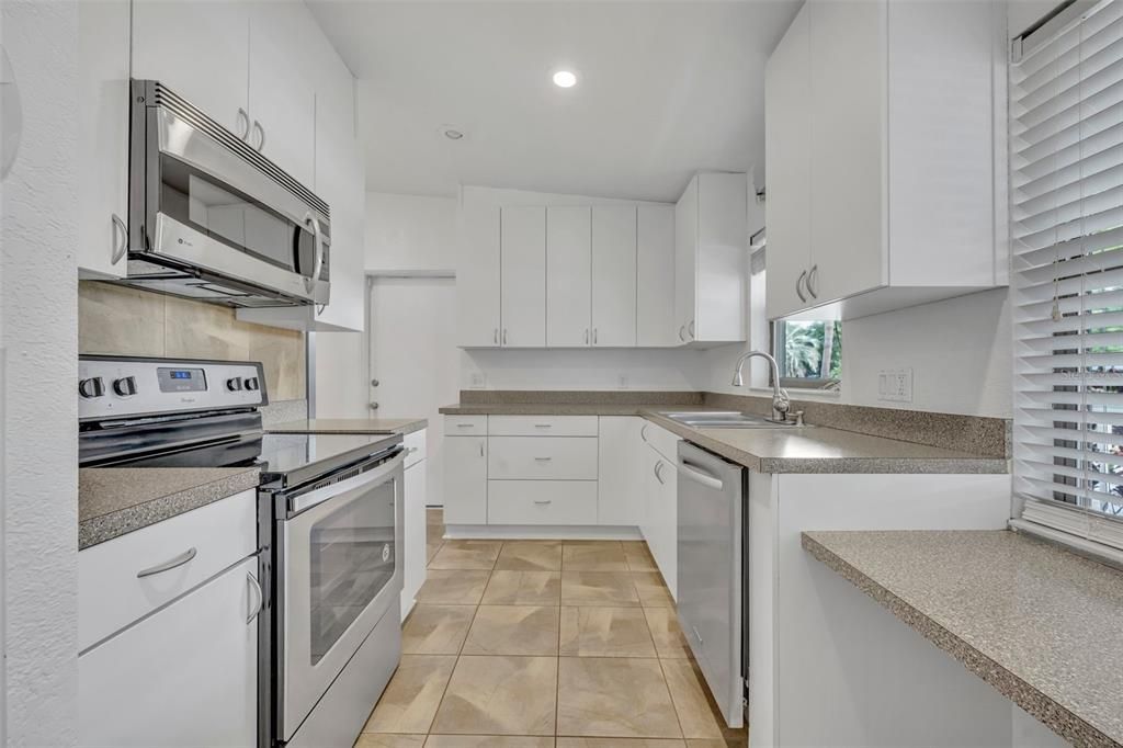 An array of deep cabinets and drawers in this light and bright kitchen