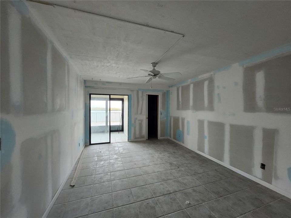 Primary bedroom leads to Florida room and balcony