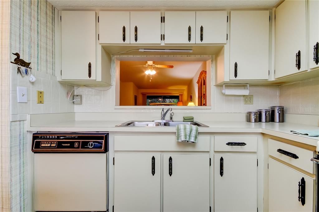 20. Kitchen (9' x 11') Features a Serving Window to the Breakfast Bar! Update Idea - To Modernize, Remove the Uppers for Open Concept Kitchen with a Peninsula!