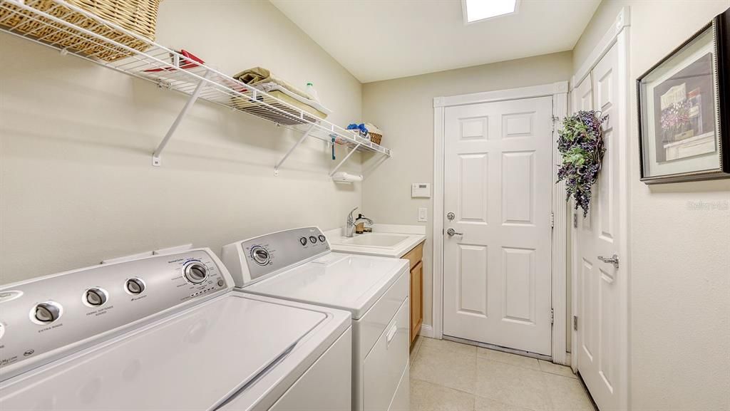 Inside Laundry with a Laundry Sink, Washer & Dryer.