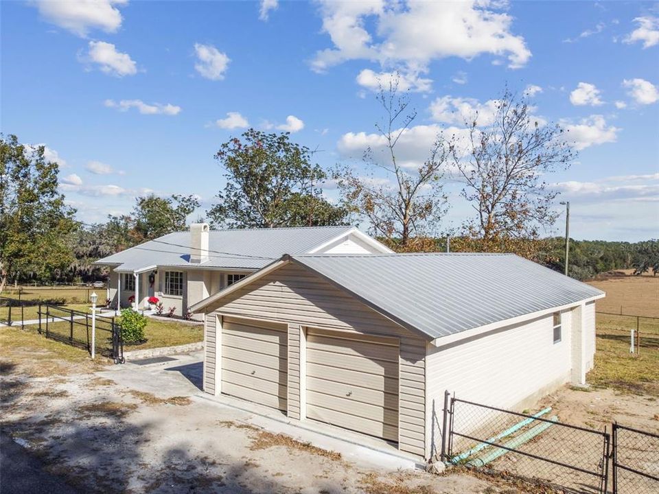 Detached garage with 3 car spaces inside.