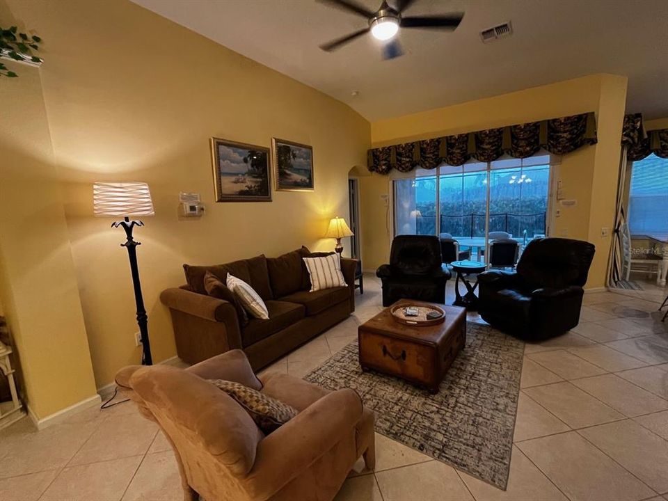 Living room with views of the lanai and pool