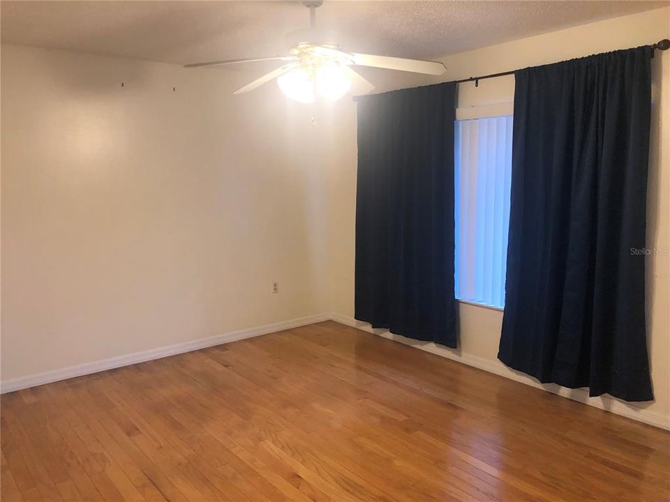 Primary Bedroom with real wood flooring