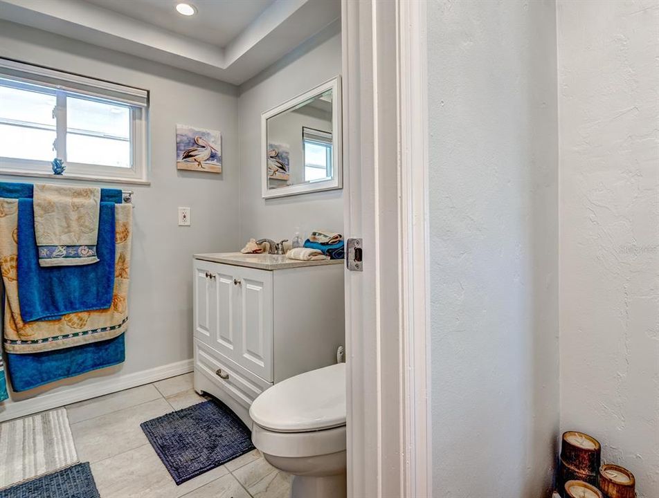 Bath 2 has been updated and features a roomy walk-in shower with designer tiles, tall vanity, comfort height commode, exhaust fan, window, recessed lighting and a very large storage closet.