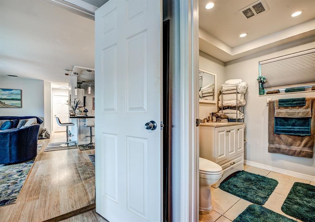 The en suite bath in the main bedroom has been updated and features a tall vanity, comfort height commode, designer tile, recessed lighting and exhaust fan. The window adds natural light to the space.