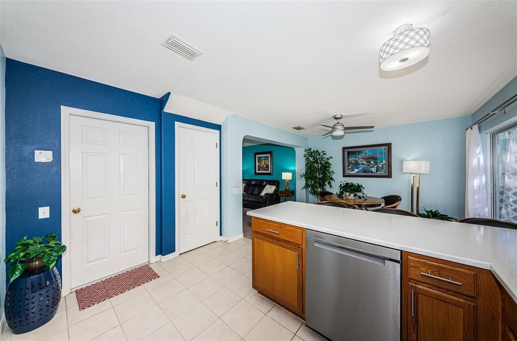 Utility closet under stairway, door to garage