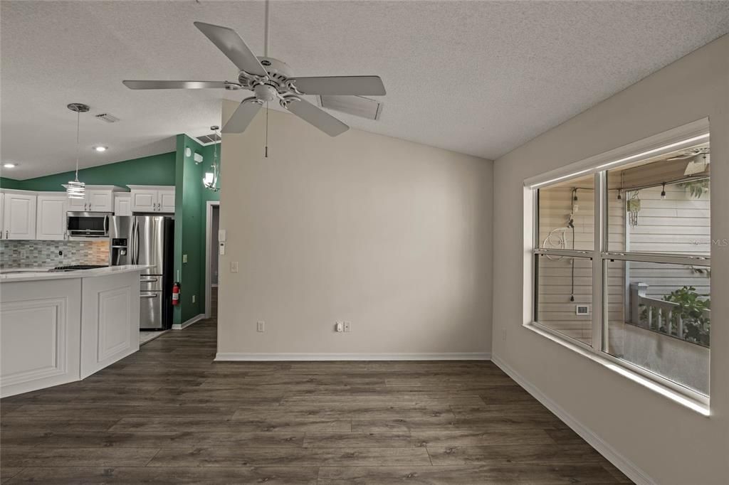 Front living room with double windows overlooking screened front porch