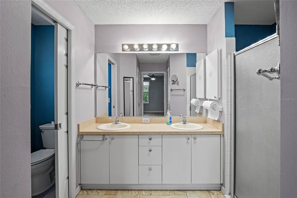 Master Bathroom with dual sinks, shower and water closet