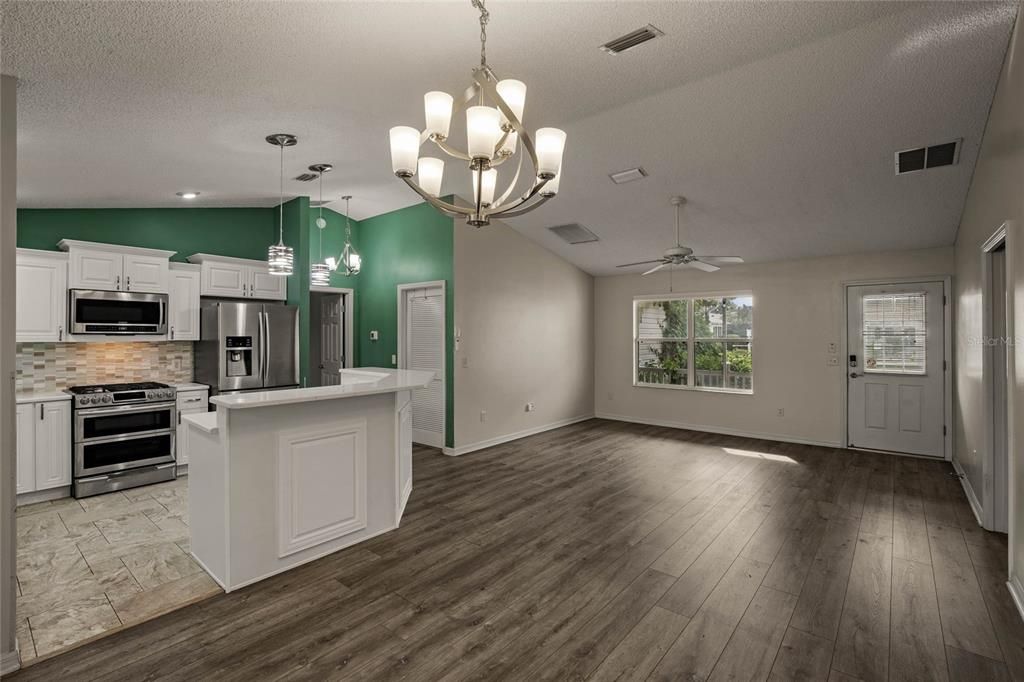 Looking from dining room into kitchen and front living room.