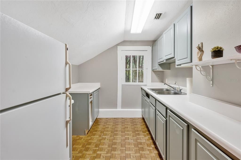 Kitchen connected to primary bedroom.