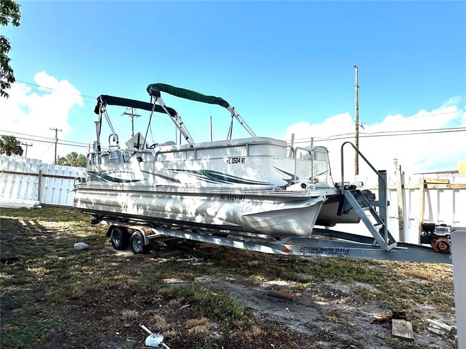 Pontoon boat- Comes with sale, located toward the back of the property