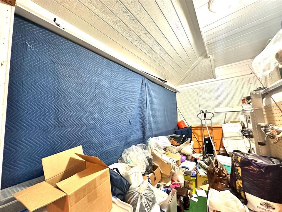 Front Inside seating area - Windows are boarded up, and the space behind the blue curtain is currently used as storage. This is the front of the business, which connects to the outside deck seating area