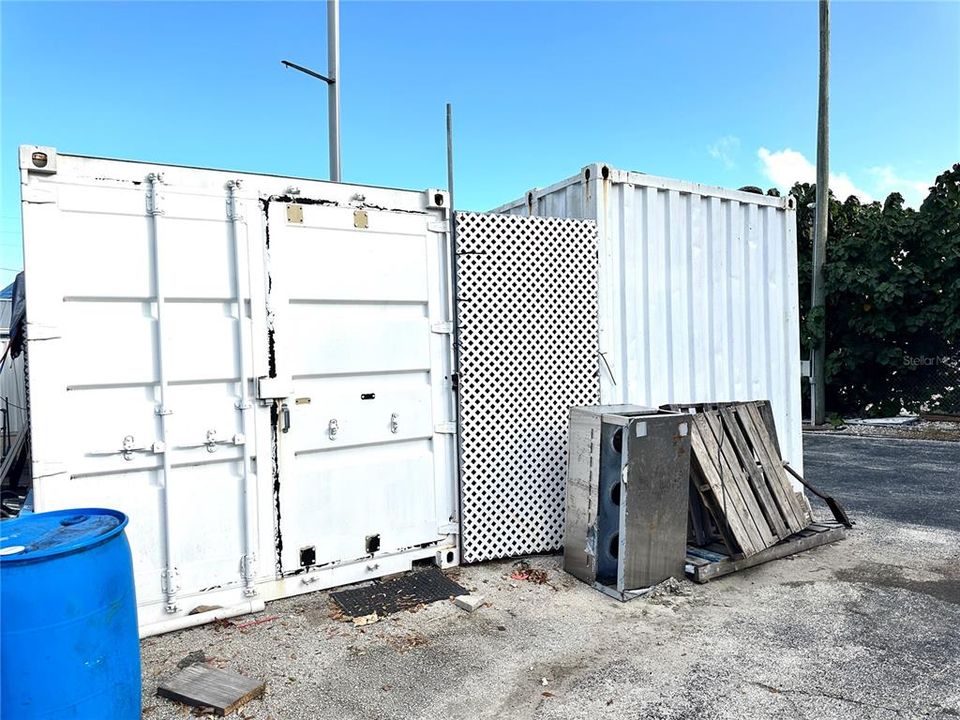 Two containers are included with the sale of the property, located toward the back of the property.