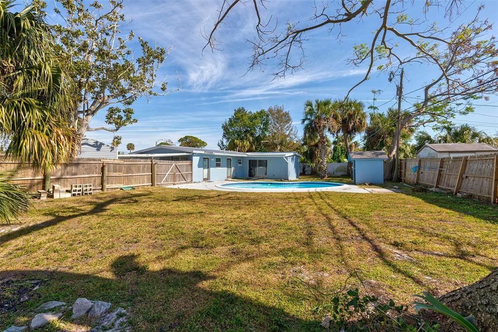 View from backyard facing pool and back of house