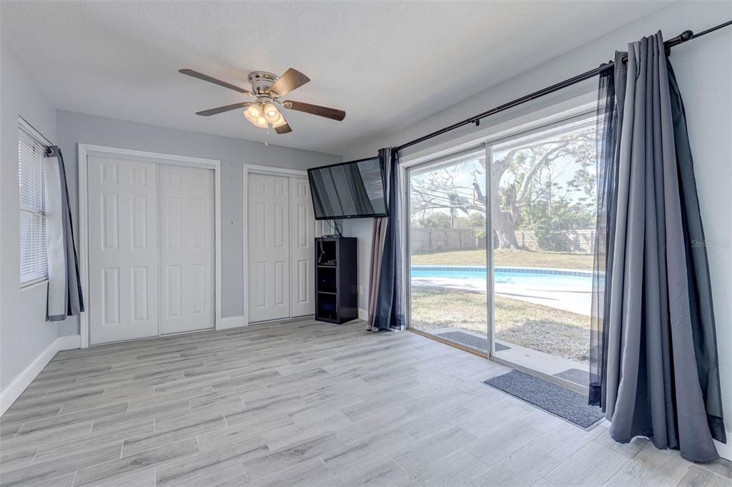 Primary Bedroom-Sliding Door leading out to the pool and backyard