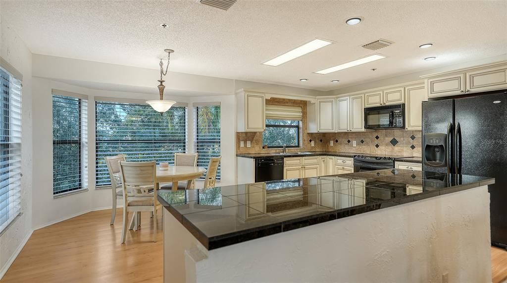 Open kitchen surrounded in windows for natural light