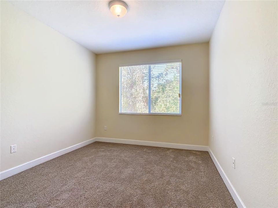 The guest bedroom looking out to the rear of the home.