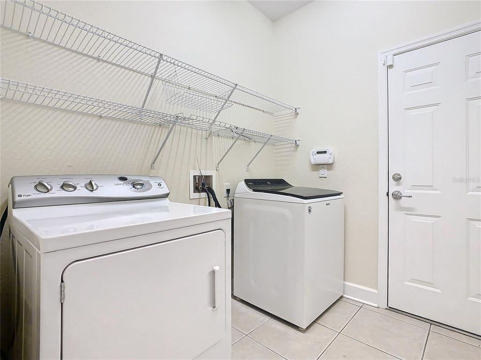 The laundry room is located in a room coming in from the garage.