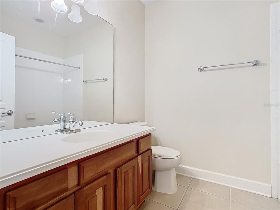 The upstairs guest bathroom with a shower in the tub.